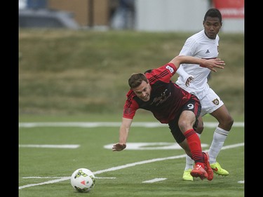 Portland Timbers striker Andy Lubahn, centre, dives towards the ball at Hellard Field in Calgary on Tuesday, June 2, 2015. The Foothills FC tied the Portland Timbers, 1-1, at the end of regular season Premier Development League play.