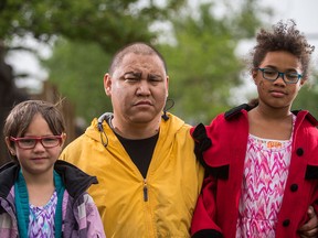Randy McDonald poses with his two daughters at their school bus stop along 52nd Street northeast in Calgary.