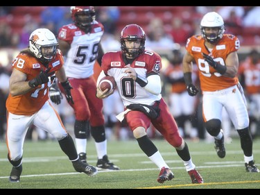 Calgary Stampeder quarterback Andrew Buckley evades the B.C. Lions at McMahon Stadium in Calgary on Friday, June 12, 2015. The Calgary Stampeders won over the B.C. Lions, 20-6, at the end of the the first pre-season exhibition game for the team.