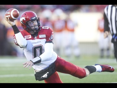 Calgary Stampeder quarterback Andrew Buckley tosses down field after evading a B.C. Lions offence at McMahon Stadium in Calgary on Friday, June 12, 2015. The Calgary Stampeders won over the B.C. Lions, 20-6, at the end of the the first pre-season exhibition game for the team.