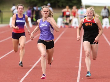Tegan Wilson, centre, dominates her competition in the WCS Games 100 metre dash at the Caltaf Track Classic in Calgary on Saturday, June 20, 2015.