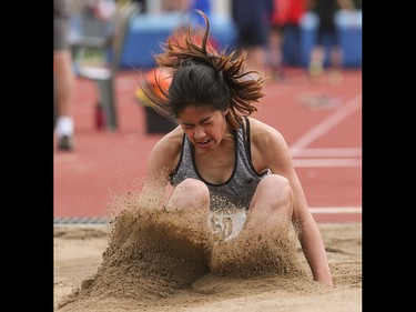 Burnadette Gonalez lands her long jump at the Caltaf Track Classic in Calgary on Saturday, June 20, 2015.