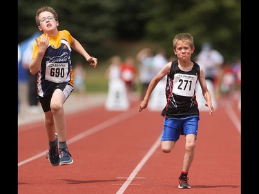 Peter Borle, left, and James Matthews race for the finish line in the boys 60 metre pee wee dash at the Caltaf Track Classic in Calgary on Saturday, June 20, 2015.