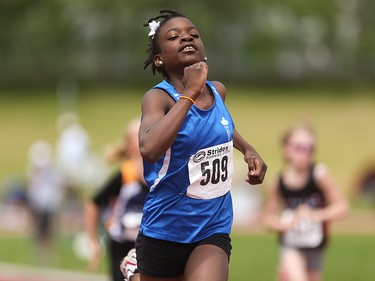 Journi Thompson, centre, outpaces her competitors in the girls 60 metre pee wee dash at the Caltaf Track Classic in Calgary on Saturday, June 20, 2015.
