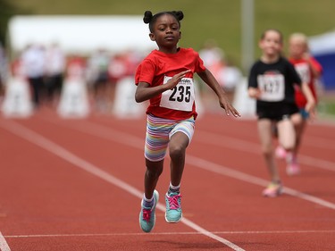 Amoya Henry, centre, dashes towards the finish line in the girls 60 metre tykes dash at the Caltaf Track Classic in Calgary on Saturday, June 20, 2015.