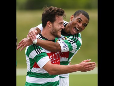 Foothills FC players Yoann Promonet, left, and Elijah Adekugbe celebrate a goal over the Washington Crossfire at Hellard Field in Calgary on Sunday, June 21, 2015.