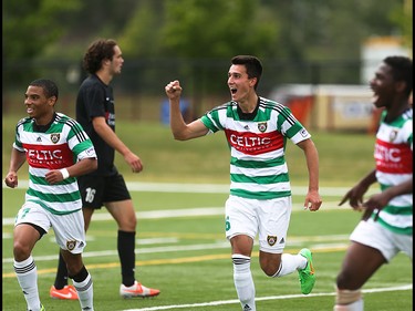 Foothills FC players Darius Ramsay, left, Dominick Zator and Elijah Adekugbe celebrate scoring over the Washington Crossfire at Hellard Field in Calgary on Sunday, June 21, 2015.