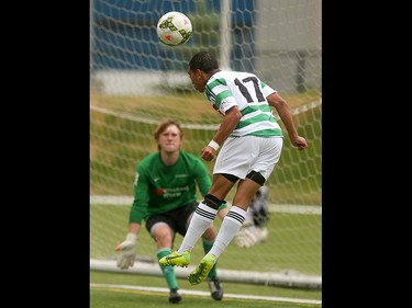 Foothills FC player Darius Ramsay, right, attempts to deflect a shot into the Washington Crossfire net at Hellard Field in Calgary on Sunday, June 21, 2015.