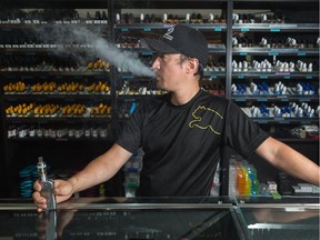 Jason Kim, owner of the Vape Depot, poses in his shop along 32nd Avenue northwest in Calgary on Monday, June 29, 2015.