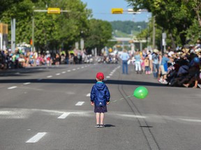 Jackson McLean, age 3, looks up the road as the lights and sounds draw nearer at the 2014 Stampede Parade in Calgary, on July 4.
