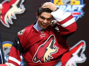 Calgary's Nick Merkley puts on his jersey after being selected 30th overall by the Arizona Coyotes in the first round of the 2015 NHL Draft at BB&T Center on June 26, 2015 in Sunrise, Florida.