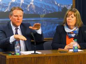 Alberta Energy Minister Marg McCuaig-Boyd, right, and Dave Mowat, the president and CEO of ATB Financial, take questions in the legislature media room after McCuaig-Boyd announces Mowat will head up a review of Alberta's oil and gas royalty structure in Edmonton, Friday, June 26.