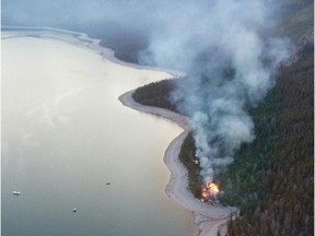 Aerial view of an illegal campfire on the beach at Lake Minnewanka.