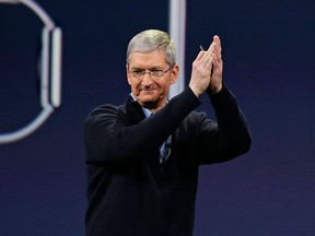 In this Monday, March 9, 2015 photo, Apple CEO Tim Cook applauds at the conclusion of the Apple "Spring Forward" launch event in San Francisco.