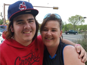 Austin Hood and Michelle Hood pose for a photo after reuniting in a Tim Horton's parking lot in Lloydminster following a nearly 18-year separation.