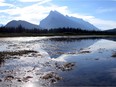 Mount Rundle casts a shadow on Vermilion Lakes in Banff National Park in August 2013. Some popular ice climbs on the mountain are closed due to a bear den in the area.
