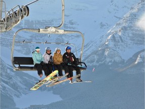 Charlie and Louise Locke and their two daughters, Robin and Kimberley, ride the Top of the World chair high above the Lake Louise Ski Resort.