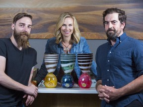 Susanne Fox, Big Rock Brewery communications, shows off the new Big Rock Eddies' awards with the rebranded awards show's producers, Dave Maess, left, and Mike Garth in Calgary. The 22-year-old commercial producing competition has rebranded itself into a short film festival. This year's theme is 'tradition'.