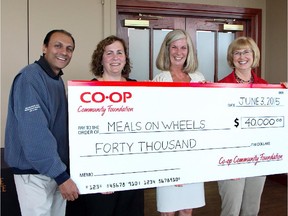 Cal 0620 Coop 1 Pictured with forty thousand reasons to smile at the 22nd Annual Co-op Community Foundation Charity Golf Classic are, from left, Calgary Co-op CEO Ken Keelor, tournament co-chair Laura Babin, Janice Curtis, executive director, Meals on Wheels and Calgary Co-op board chair Peggy  LeSueur.