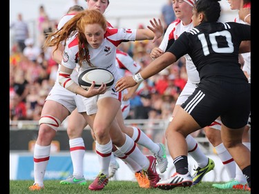 Team Canada's Andrea Burk heads for the goal line during a Rugby Canada Super Series game against New Zealand at Calgary Rugby Park on Saturday June 27, 2015.