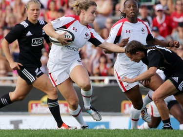 Team Canada's Alexandra Tessier dodges a New Zealand tackle during their Rugby Canada Super Series game at Calgary Rugby Park on Saturday June 27, 2015.