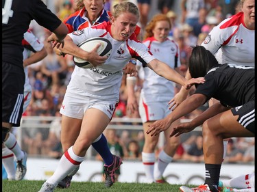 Team Canada's Alexandra Tessier fights a New Zealand tackle during their Rugby Canada Super Series game at Calgary Rugby Park on Saturday June 27, 2015.