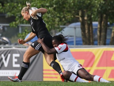 Team Canada's Latoya Blackwood tackles New Zealand's Chelsea Alley in the Rugby Canada Super Series at Calgary Rugby Park on Saturday June 27, 2015.