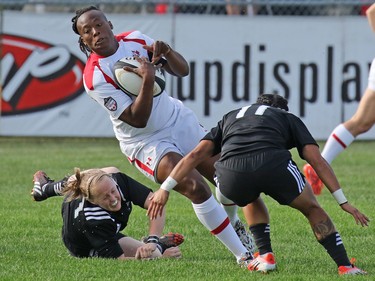 Team Canada's Latoya Blackwood tries to duck a New Zealand tackle during their Rugby Canada Super Series game at Calgary Rugby Park on Saturday June 27, 2015.