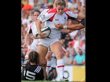 Team Canada's Alexandra Tessier fights a New Zealand tackle during their Rugby Canada Super Series game at Calgary Rugby Park on Saturday June 27, 2015.