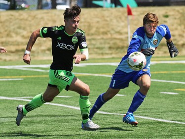 The Seattle Sounders' Florion Valot and Calgary Foothills FC keeper Hunter Brett chase a loose ball on the edge of the crease during their match at Hellard Field on Sunday June 28, 2015.