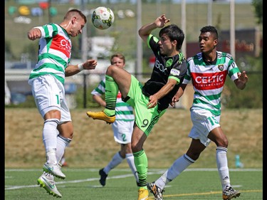Calgary Foothills FC defender Tyrin Hutchings heads the ball against the Seattle Sounders' Guillermo Delgado during their match at Hellard Field on Sunday June 28, 2015.