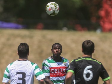 Foothills FC defender Bradley Kamdem Fewo, centre, puffs up as he heads the ball at Hellard Field in Calgary on Sunday, June 28, 2015. Foothills FC lost to the Seattle Sounders, 4-0, in regular season Premiere Development League play.