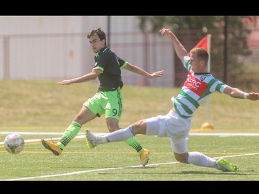 Foothills FC defender Tyrin Hutchings, right, attempts a slide tackle at Hellard Field in Calgary on Sunday, June 28, 2015. Foothills FC lost to the Seattle Sounders, 4-0, in regular season Premiere Development League play.