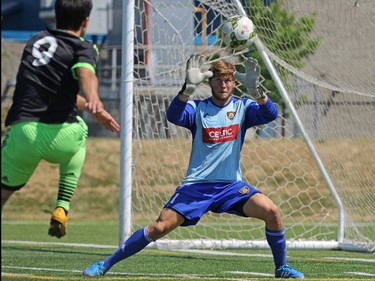 Calgary Foothills FC goalkeeper Hunter Brett stopped this shot by the Seattle Sounders Guillermo Delgado during a match against Calgary Foothills FC at Hellard Field on Sunday June 28, 2015.