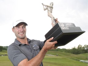 Calgary's James Love hoists the trophy after winning the Alberta Open title on Tuesday at Carnmoney Golf Club.