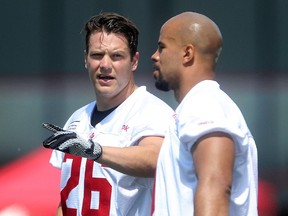 Calgary Stampeders Rob Cote, left, and Jon Cornish chat at practice. Cote was named one of four Stamps captains on Monday.