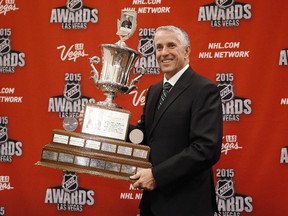 Calgary Flames coach Bob Hartley poses with the Jack Adams Award trophy after winning the award on Wednesday night in Las Vegas.