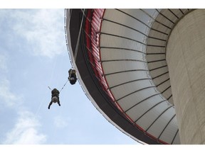 Members of the Calgary Kings Own army reserves, Captain Charlene Brien and Lt. Joanna Van Damme were testing their skills by repelling down the side of the Calgary Tower on Friday, June 19, 2015. They are doing a big event Saturday morning with 40 of their members repelling off the tower starting at 8 a.m.