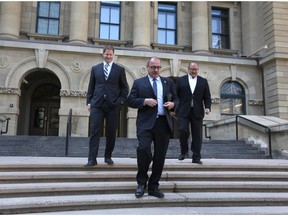 Interim Tory leader Ric McIver is flanked by PC caucus members Rick Fraser, left and Richard Gotfried.
