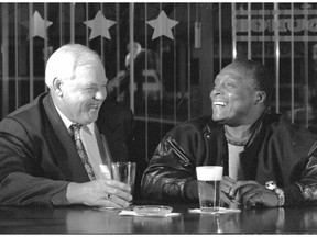 Rivals on the field, Wayne Harris, left, and George Reed were friends off it. Here they are sharing a beverage in 1994.