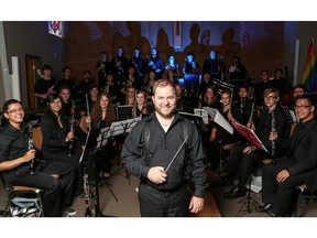 Carlos Foggin poses with the Calgary Wind Youth Ensemble at the Deer Park United Church in Calgary on Sunday, June 21, 2015.