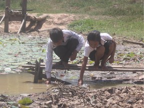 Children gather water from a pond at their school in Cambodia. Fortunately, Samaritan’s Purse has just installed a filter that turns this dirty pond water into a safe source in minutes.