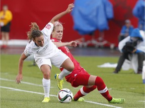 Canada's Sophie Schmidt and New Zealand's Annalie Longo battle for the ball on June 11. Edmonton could have done so much more to liven the atmosphere and create a sense of anticipation for the FIFA tournament, says reader.