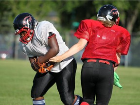 Running back Tolu Fasuba takes the hand-off from quarterback Ashley Kellsey-Shoemaker.  The Calgary Rage women's tackle football team is enjoying a winning season as it vies to become the first Calgary team in the women's football version of the Grey Cup.