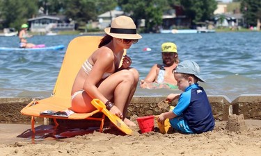 Calgary's Alysa Ferrera and her son Nathan Altizer, 3, made sand castles in the newly opened Anniversary Park beach in Chestermere on June 11, 2015 as temperatures again climbed into the high 20's on June 11, 2015.
