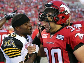 Calgary Stampeders Rene Paredes, right, gets congratulated by Brandon Banks after their win against the Hamilton Tiger-Cats during their season opener at McMahon Stadium, on June 26, 2015.