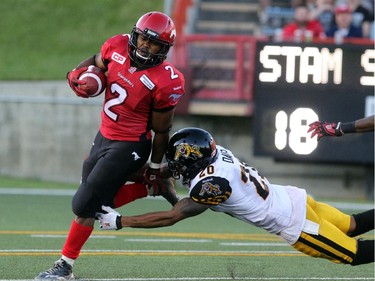 Calgary Stampeders Tim Brown out cats the Hamilton Tiger-Cats Emanuel Davis during their season opener at McMahon Stadium, on June 26, 2015.