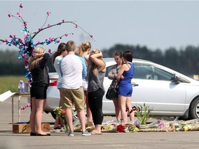 A group of students gathered around a memorial in the parking lot of Chestermere High School for Jaydon Sommerfeld, who passed away on June 10 following an accident the day before at the intersection of Highways 1 and 791.