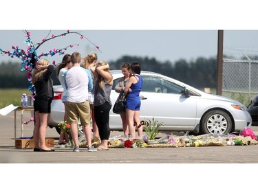 A group of students gathered around a memorial in the parking lot of Chestermere High School for Jaydon Sommerfeld who passed away on June 10, 2015 following an accident the day before at the intersection of Highways 1 and 791.