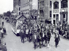 This image from the 1930's shows Shriners leading a parade float pulled by heavy horses in the Stampede parade.